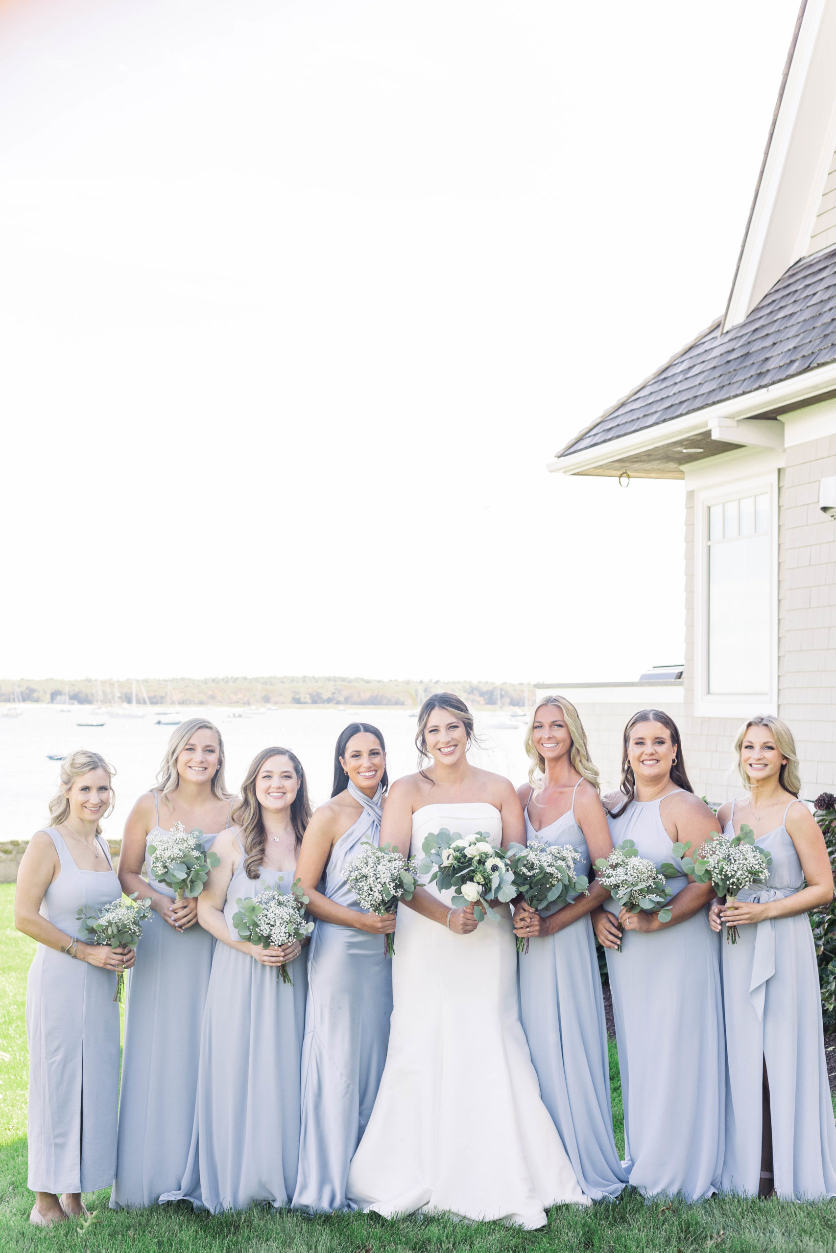 bridesmaids in lavender surrounding a bride Bay Club Mattapoisett wedding