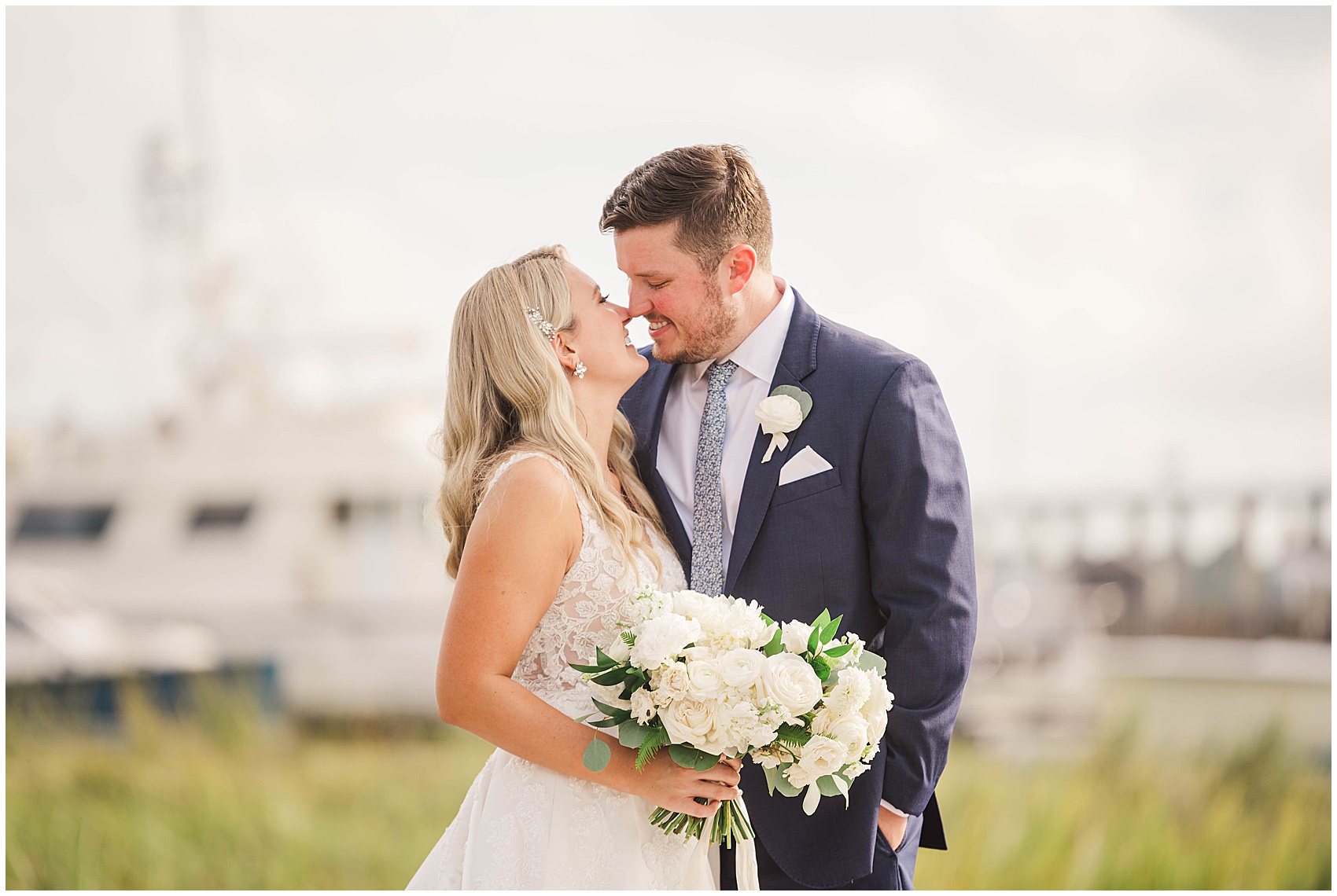 bride and groom nuzzling on a dock near the Historic Rice mill wedding venue