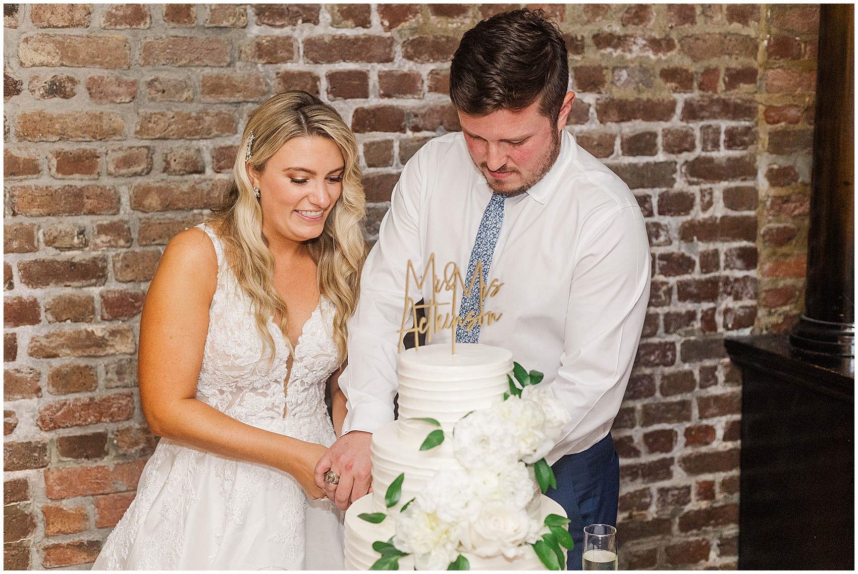 bride and groom cutting the cake at their Historic Rice mill wedding