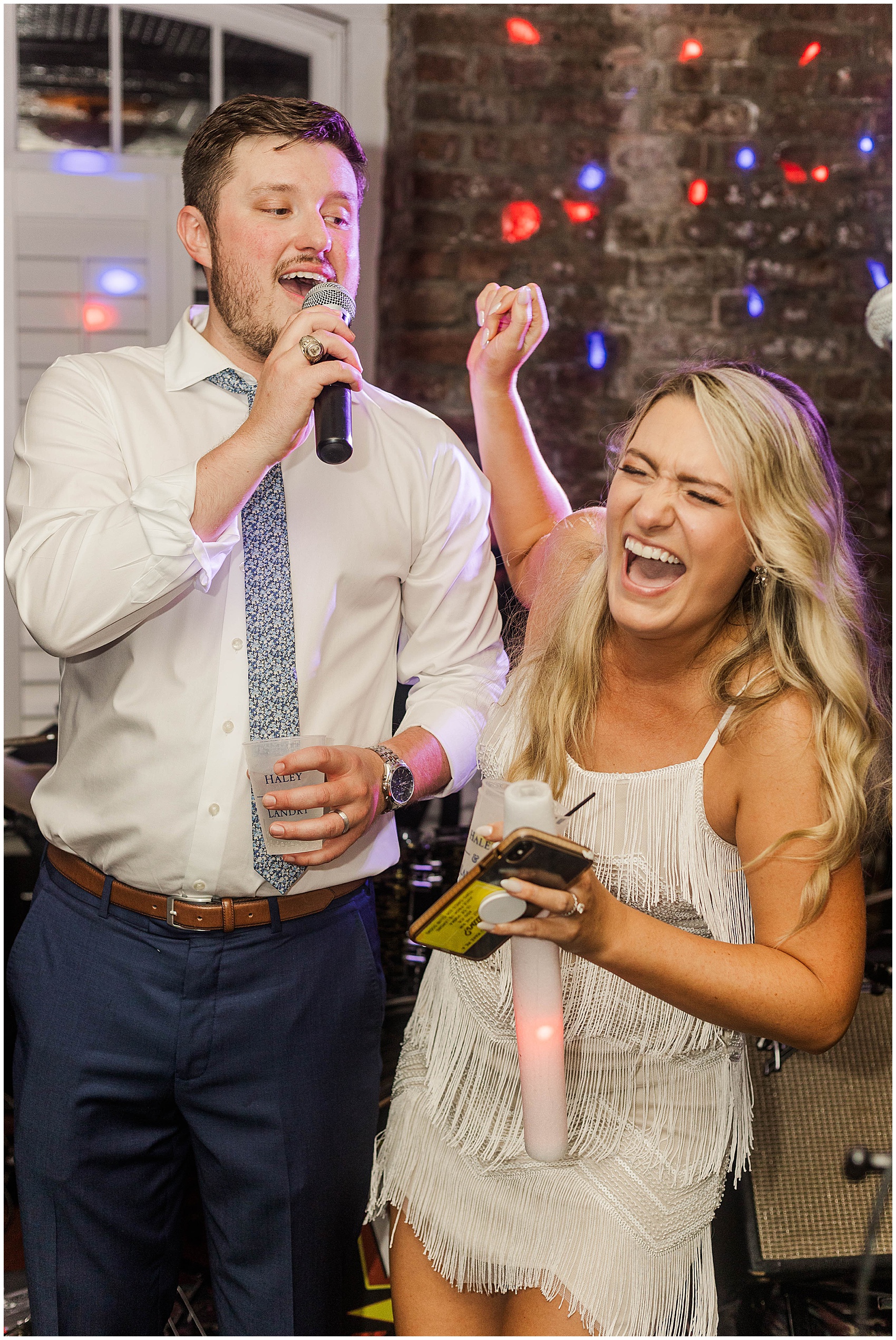 bride and groom singing karaoke at the Historic Rice mill wedding venue